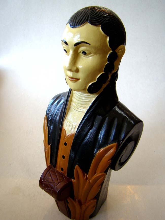 A miniature carved ship's figurehead